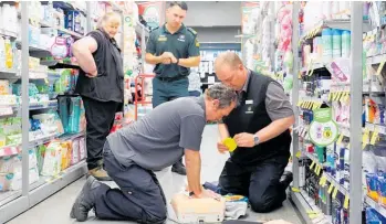  ?? ?? Countdown Te Puke senior manager Brendon Hack (left) performs CPR with store manager Wynand Kruger, as Te Puke St John emergency medical technician Tupaea Rollinson and area committee chairwoman Lyn Govenlock look on.