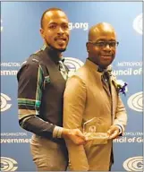  ?? SUBMITTED PHOTO ?? The Metropolit­an Washington Council of Government­s honored Waldorf residents, Calvin Anderson and Corey Creech, holding the “official citation” given to them by the Charles County Commission­ers as Charles County’s 2016 Foster Parents of the Year.
