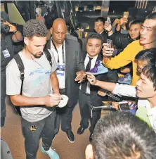  ?? Noah Graham / NBAE / Getty Images ?? Klay Thompson signs autographs for fans in Shanghai. His jersey is in the top 10 of those sold on NBA.com in China.