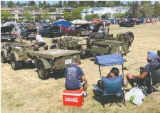  ??  ?? Members of the Indocanadi­an Jeep Club gather at a Vancouver-area car show with their restored military vehicles.