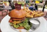  ?? ?? Bacon, cheddar and an onion ring top the Legendary Steak Burger at Hard Rock Cafe.
fogodechao.com