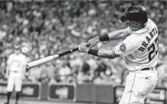  ?? Brett Coomer / Staff photograph­er ?? Michael Brantley hits a solo home run to give the Astros a 5-1 lead during the eighth inning of Game 5 of the American League Division Series at Minute Maid Park.