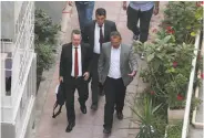  ?? AFP / Getty Images ?? U.S. pastor Andrew Brunson (left) is escorted to his home following a trial in western Izmir province.