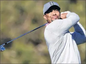  ?? AP PHOTO ?? In this Friday, Jan. 27, 2017, photo, Tiger Woods watches his tee shot on the ninth hole of the North Course during the second round of the Farmers Insurance Open tournament at Torrey Pines Golf Course in San Diego. Tiger Woods is returning to...