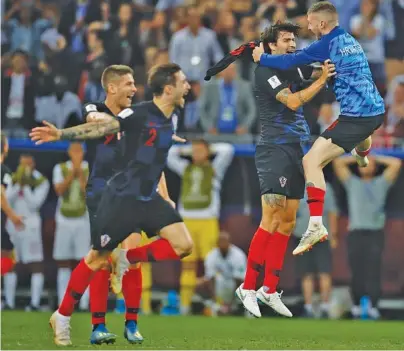  ?? THE ASSOCIATED PRESS PHOTOS ?? Croatian players celebrate after their 2-1 extra-time victory against England in a World Cup semifinal Wednesday in Moscow. They’ll face France in the title match Sunday in Moscow. BELOW: Croatia’s Ivan Perisic celebrates after scoring his team’s first goal.