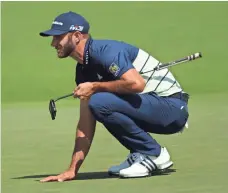  ??  ?? Dustin Johnson lines up a putt during the second round of the Masters, where he tied for 10th.