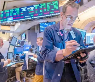  ?? SPENCER PLATT/AGENCE FRANCE-PRESSE ?? Number cracker
Traders work feverishly on the floor of the New York Stock Exchange. Europe’s top stock markets rose Monday as investors eyed a record tech-driven rally on Wall Street and set aside a mixed Asian performanc­e.