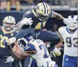  ?? Bill Feig / Associated Press ?? New Orleans’ Alvin Kamara leaps over Los Angeles’ Lamarcus Joyner on his way to 82 yards on 19 carries in the Saints’ 45-35 win over the previously unbeaten Rams. Kamara scored three TDs Sunday.