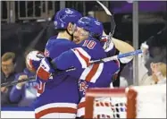  ?? ADAM HUNGER AP ?? Rangers left wing Artemi Panarin (10) hugs Chris Kreider after scoring the game-winning goal in overtime.