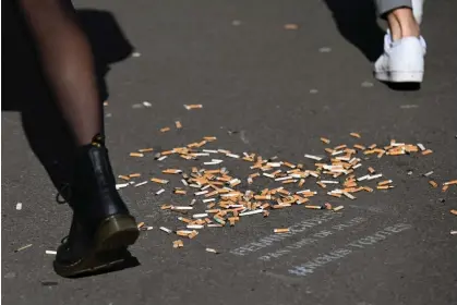  ?? ?? Smokers stub out nearly 800,000 metric tonnes of cigarettes every year. Photograph: Emmanuel Dunand/AFP/Getty Images