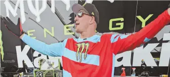  ?? STAFF PHOTOS BY PATRICK WHITTEMORE ?? READY TO RIDE: New England Patriots tight end Rob Gronkowski speaks to the media, above, and flexes in a motocross suit, left, yesterday at Gillette Stadium.