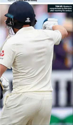  ??  ?? TON UP: Woakes is congratula­ted by Bairstow after reaching his century