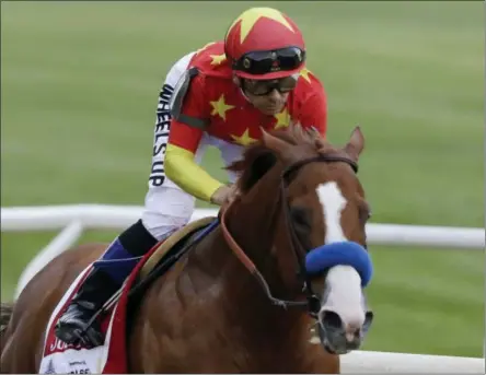  ?? MARK LENNIHAN — THE ASSOCIATED PRESS ?? Justify, right, ridden Mike Smith, heads into the far turn during the Belmont Stakes horse race, Saturday at Belmont Park in Elmont, N.Y. Justify won the race, to claim horse racing’s Triple Crown.