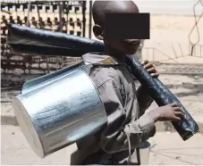  ??  ?? A child sells metal buckets and door stoppers at Mpopoma shopping centre, Bulawayo, in this file photo