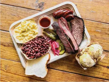  ?? Photos by J.C. Reid/Contributo­r ?? Heffernan Barbecue trailer offers brisket, ribs and sausage with red beans and rice and mac ’n’ cheese.