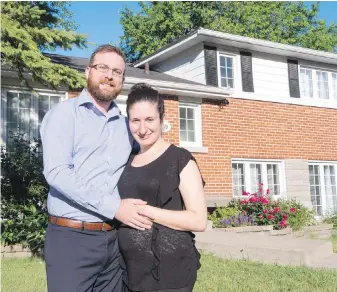  ?? RYAN REMIORZ, THE CANADIAN PRESS ?? Elena Trigiani and her husband, Thomas Poirier, paid 15 per cent above the asking price to come out on top in a bidding war for their Montreal-area home. Bidding wars have been a common occurrence in Toronto and Vancouver, but they’ve been rare in Montreal.