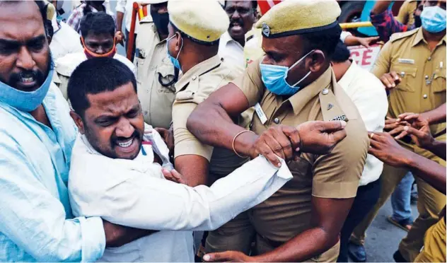  ?? Agence France-presse ?? ↑
Police try to control members of the CPI during a protest against the new agricultur­al bills in Chennai on Monday.