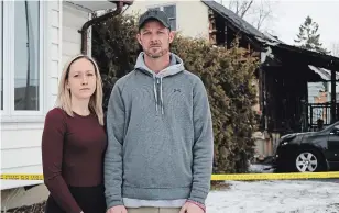  ?? MATTHEW P. BARKER EXAMINER ?? Adam Hayes and his girlfriend, Tasha Aubin, stand on their property in front of the yellow fire tape that separates part of their property damaged by a house fire that broke out on the weekend.