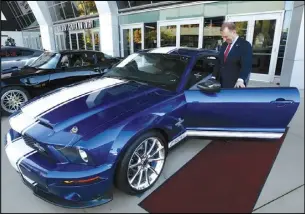  ?? RICH PEDRONCELL­I/AP PHOTO ?? In this 2019, file photo, McGregor Scott, who was then the US Attorney for the Eastern District of California, looks over a 2007 Ford Shelby GT500 displayed in Sacramento, that was among the vehicles seized by the federal government to be auctioned off.