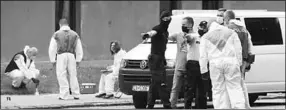  ??  ?? Police officers and forensic technician­s wearing face masks work at the scene of the reported assault. (Photo: Reuters)