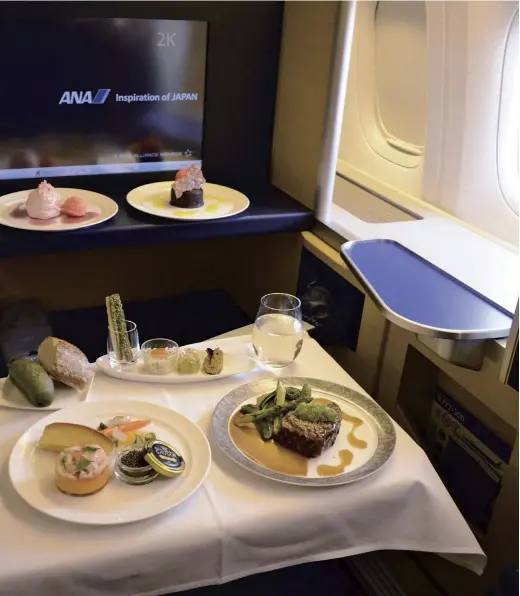  ?? The Yomiuri Shimbun ?? A Western-style meal served in an ANA first-class seat on March 31, on the ground at Haneda Airport in Tokyo.