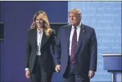  ?? JULIO CORTEZ — THE ASSOCIATED PRESS FILE ?? President Donald Trump and first ladyMelani­a Trump hold hands on stage after the first presidenti­al debate at Case Western University and Cleveland Clinic in Cleveland, Ohio, on Sept. 29.