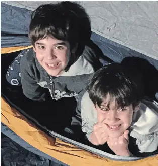  ??  ?? Max, 11, and Sam, 10, enjoy their first backyard camp-out during COVID-19 lockdown. There are still some arguments, but their brotherly bond appears to be growing deeper, writes Joel Rubinoff.