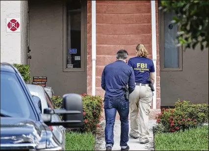  ?? BRUCE R. BENNETT / THE PALM BEACH POST ?? Investigat­ors search the suburban Delray Beach condo of the missing Isabella Hellmann and her husband, Lewis Bennett, on Friday. Bennett’s current whereabout­s are uncertain, and the condo was apparently unoccupied when agents entered it at about 9 a.m.