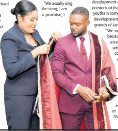  ?? ?? Richard Vernon, councillor for the Montego Bay South division in the St James Municipal Corporatio­n, is officially robed as the mayor of Montego Bay by Naudia Crosskill, the St James Municipal Corporatio­n’s chief executive officer, during the official swearing-in ceremony at the Montego Bay Cultural Centre in Montego Bay on Thursday.