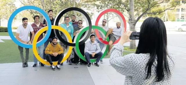  ?? FILE ?? A group of students from Uruguay pose for a souvenir picture on the Olympic Rings set outside the Olympic Stadium in Tokyo, Japan, on Saturday, March 21, 2020.