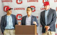  ?? STAFF PHOTO BY DOUG STRICKLAND ?? Cincinnati Reds senior director of player developmen­t Eric Lee speaks Tuesday afternoon at AT&amp;T Field, as Chattanoog­a Lookouts co-owners Jason Freier, left, and John Woods, right, look on.