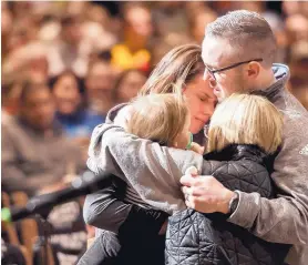  ?? DOUGAL BROWNLIE/THE GAZETTE ?? Gracie Parrish, left, is embraced as family, friends, and community attend a remembranc­e and candleligh­t vigil for her husband, Deputy Zackari Parrish, at Mission Hills Church in Littleton, Colo., on Monday.