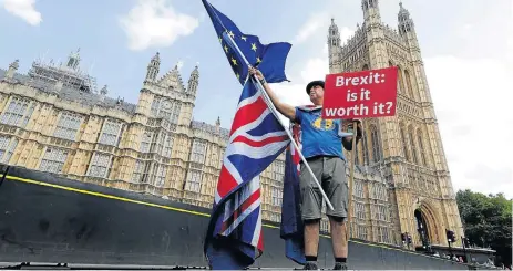  ?? /Reuters ?? Flagging chaos: A man holds an anti-Brexit banner on Westminste­r Bridge, in central London. The European Commission has called on EU states to raise their level of preparatio­n for a disruptive exit from the EU by Britain in March 2019.