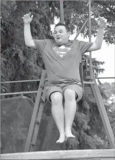  ?? Herald photo by J.W. Schnarr ?? Taylor Elderton braces for impact after being knocked off his perch in a dunk tank at Shelter Me! Party in the Park at Galt Gardens on Saturday.