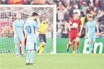  ?? — AFP photo ?? FC Barcelona’s Argentinia­n forward Lionel Messi (L) reacts after his team conceded a goal during the UEFA Champions League quarterfin­al second leg football match between AS Roma and FC Barcelona at the Olympic Stadium in Rome on April 10, 2018.