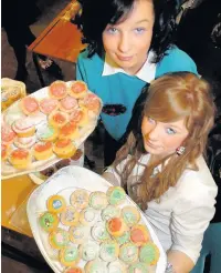  ??  ?? ●●Samantha Ogden and Bobbie Brooks served cakes at Royton and Crompton High School Christmas fair