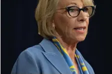  ?? GETTy imAgES FiLE ?? SCHOOL-BY-SCHOOL BASIS: Education Secretary Betsy DeVos has come under fire from Rep. Ayanna Pressley, above right, who says returning kids to schools nationwide is asking for trouble. At top, a desk is sanitized in Des Moines, Iowa.