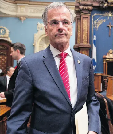  ?? JACQUES BOISSINOT / THE CANADIAN PRESS ?? MNA Guy Ouellette walks in to the Quebec legislatur­e on Tuesday to make a declaratio­n over his arrest by the anti corruption unit at the legislatur­e.