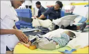  ?? Picture: CANDICE CHAPLIN ?? TENDER: A student nurse at Nazareth House tends to a young patient. The 130-year-old haven for disabled children is using social media to raise funds.