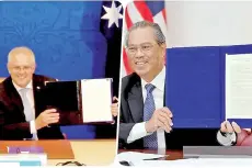  ??  ?? Muhyiddin Yassin and Scott John Morrison showing a joint statement on the Malaysia-Australia Comprehens­ive Strategic Partnershi­p Meeting in a video conference yesterday.