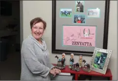  ?? The Sentinel-Record/Richard Rasmussen ?? LIFETIME OF WINNERS: Oaklawn Park’s Horsemen’s Liaison Deborah Lokanc, pictured with her collection of racing memorabili­a, says the most fulfilling part of her career in horse racing is spending time with the horses. In her time as horsemen’s liaison,...