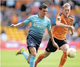  ??  ?? Jack Cork looking purposeful at the Molineux (above left) while right, Kyle Naughton, who was in excellent form, gets on the ball