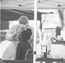  ?? COURANTFIL­E PHOTO ?? Eunique Coleman, 17, sits for a COVID-19 test in May at a mobile testing site in Hartford organized by Sen. Douglas McCrory, Hartford HealthCare, Phillips Metropolit­an C.M.E. Church and The Community Safety Coalition.