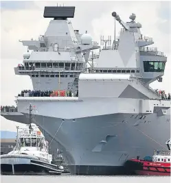  ?? Picture: Getty Images. ?? The crew of HMS Queen Elizabeth crowd the deck as the aircraft carrier sets sail from Rosyth for the first time for sea trials.