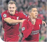  ??  ?? Shaqiri celebrates with Firmino in midweek