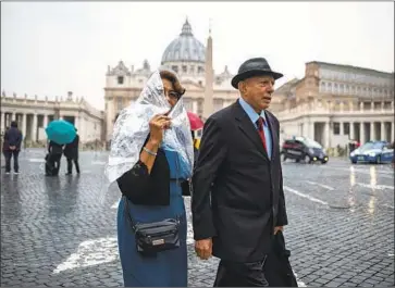  ?? Antonio Masiello For The Times ?? MARIA HILDA and Guillermo Gonzalez, a Salvadoran couple from Granada Hills, walk in Vatican City on Thursday. While in college, the couple befriended Archbishop Oscar Romero, who will be canonized Sunday.