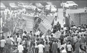  ?? AP/OLU AJAYI ?? People gather outside a church after a blast Sunday in Kaduna, Nigeria.