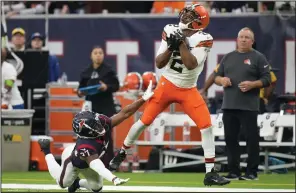  ?? (AP/Eric Christian Smith) ?? Cleveland Browns wide receiver Amari Cooper (right) hauls in a touchdown pass as Houston Texans cornerback D’Angelo Ross defends during the first half Sunday at NRG Stadium in Houston.