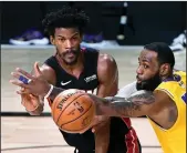  ?? WALLY SKALIJ/LOS ANGELES TIMES ?? The Lakers' LeBron James tries to break up a pass from the Heat's Jimmy Butler in Game 4 of the NBA FInals in Orlando on Oct. 6.