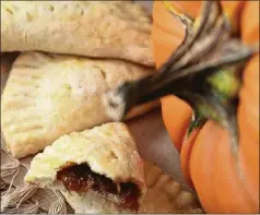  ?? JEANINE THURSTON ?? LEFT: Pumpkin Empanadas from Yvette Marquez-Sharpnack’s cookbook, “Muy Bueno” (Hippocrene Books, 2012). Her grandma made the pumpkin filling from leftover jack-o’-lanterns.